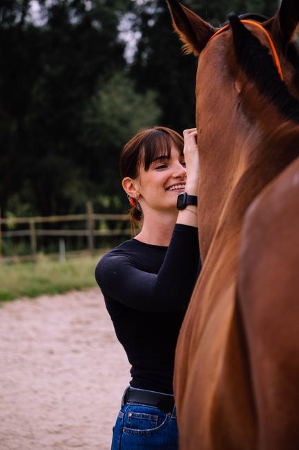 pexels photo 11689021 11689021 Smiling woman interacting with a horse outdoors, showcasing companionship.